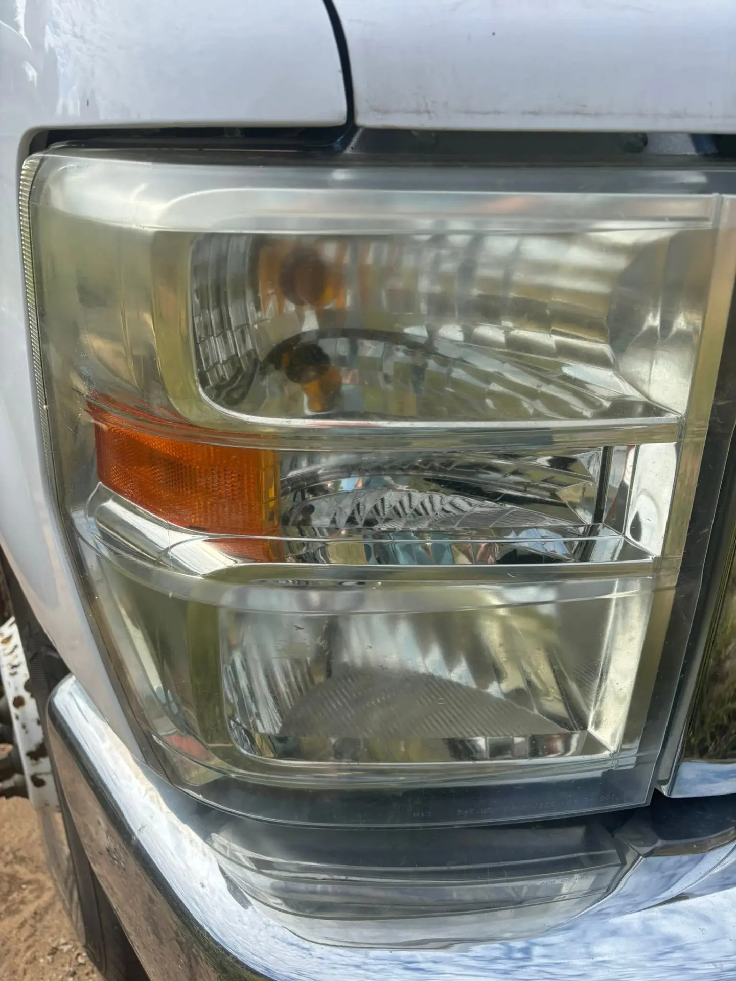 Second yellowed RV headlight lens before restoration