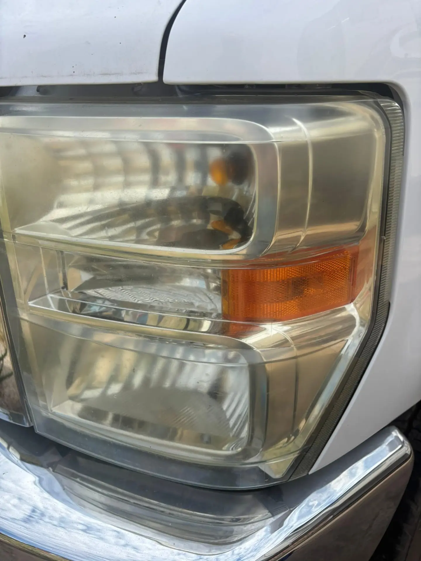 Yellowed, hazy RV headlight lens before restoration
