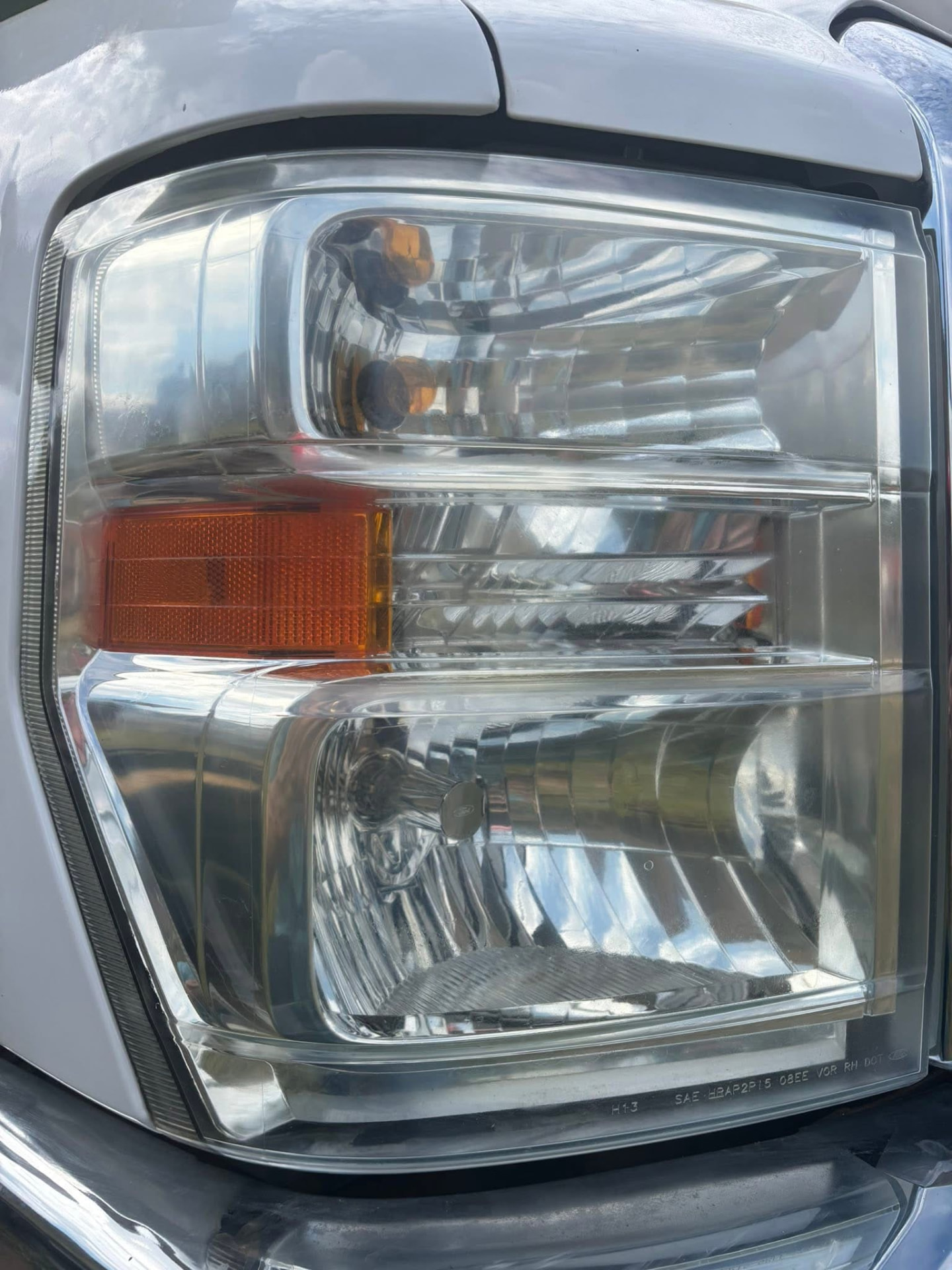The same RV headlight restored to clear after polishing and Ceramic UV sealing
